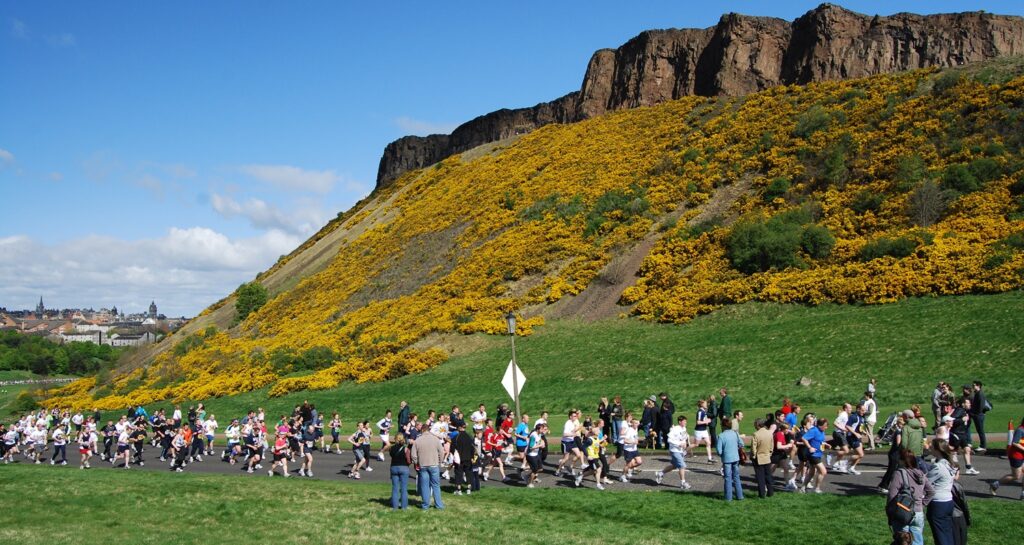 People running at the base of Arthurs seat for the Great Run, Holyrood Park, Edinburgh, Scotland