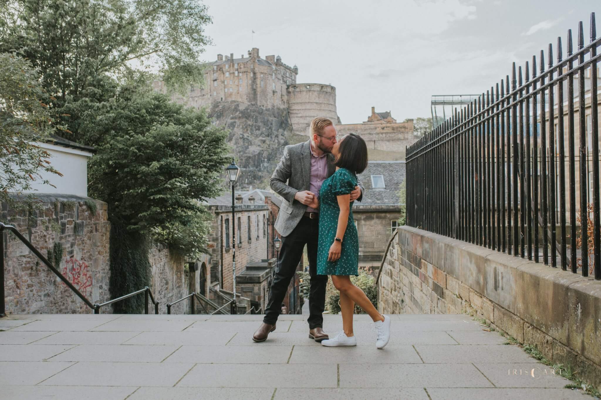 Couple celebrating engagement on Vennel steps in Edinburgh with Castle in the background