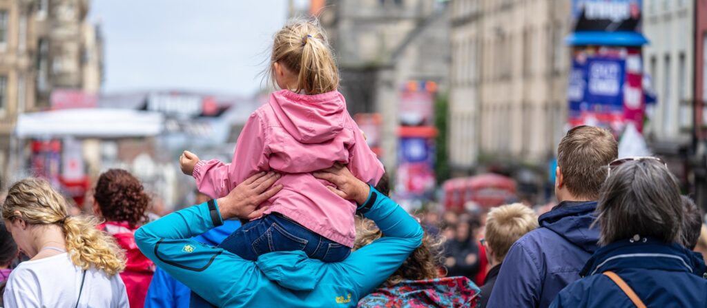 Little girl On Her Dads Shoulders.Edinburgh Festival Fringe