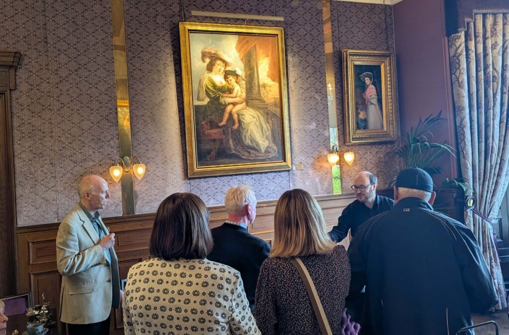 edinburgh gin ambassador giving a talk in front of a painting at the Bonham hotel 