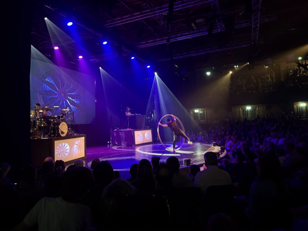 an acrobat doing cartwheels in a hula hoop at 360 ALLSTARS